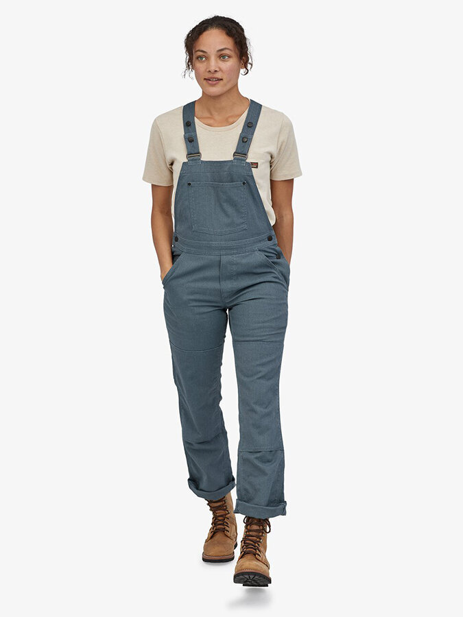 Ethically Made Workwear for Women: Patagonia's dusty blue overalls, cream tee, and brown work boots